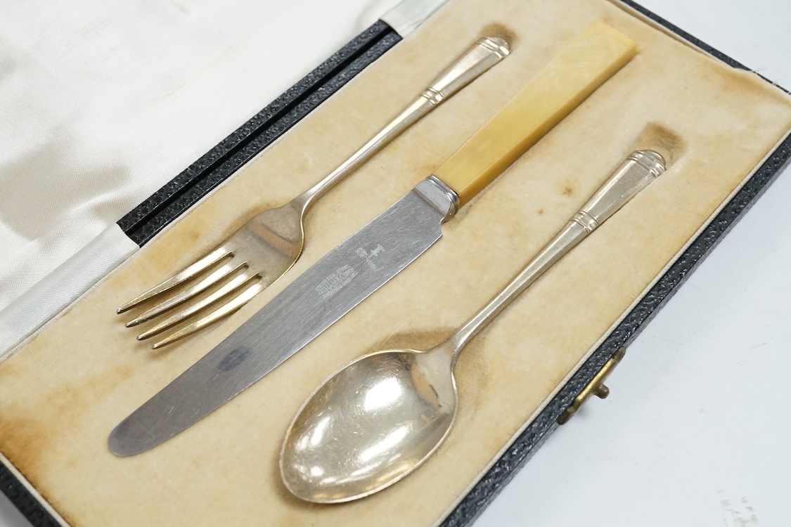 Three assorted silver christening sets including spoon, fork and napkin ring by William Hutton & Sons, London, 1896, one other set with steel knife, two cased sets of silver coffee spoons and a cased set of six Japanese